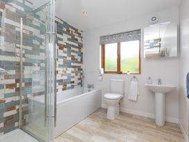 A bathroom with shower, bathtub, toilet and sink at Branock, Tor Down Quarry St Breward