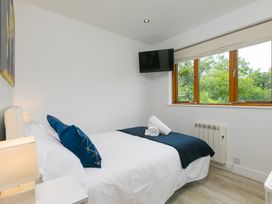 A bedroom with a bed and window at Branock, Tor Down Quarry in St Breward