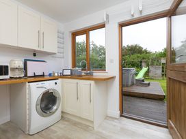 A kitchen with a washing machine and sink at Branock, Tor Down Quarry St Breward