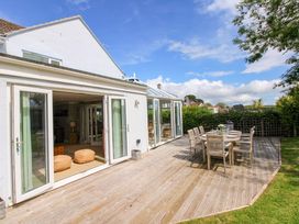 An outdoor patio with a table and chairs at Welsummer in Salcombe