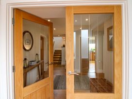 An entrance hall with double doors and a console table at Welsummer Salcombe