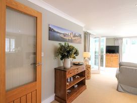A living room with furniture and a television at Welsummer in Salcombe