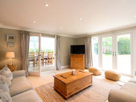 A living room with a coffee table and TV at Welsummer in Salcombe