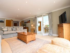 A living room with a sofa and coffee table at Welsummer in Salcombe