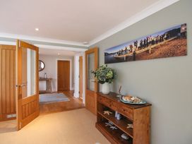 A hallway with a console table and wall art at Welsummer in Salcombe