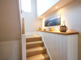 A staircase with decorative items at Welsummer in Salcombe