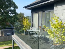 A balcony with a table and chairs at Estuary Watch in Lelant near Carbis Bay