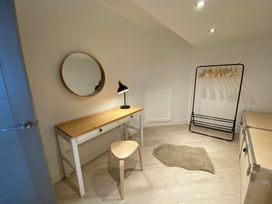 A dressing room with a desk and lamp at Estuary Watch Lelant near Carbis Bay