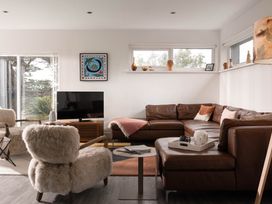 A living room with a sofa and television at Estuary Watch Lelant near Carbis Bay