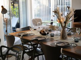 A dining room with a table set for a meal at Estuary Watch in Lelant near Carbis Bay