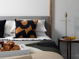 A bedroom with a bed and a bedside table at Estuary Watch Lelant near Carbis Bay