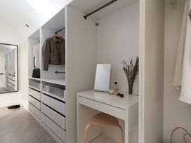 A dressing room with a mirror and dresser at Estuary Watch in Lelant near Carbis Bay