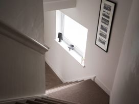 A staircase with a window and lamp at Estuary Watch in Lelant near Carbis Bay