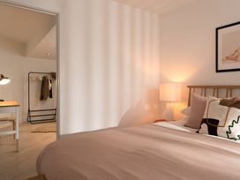 A bedroom with a bed and lamp at Estuary Watch, Lelant near Carbis Bay