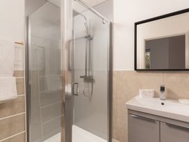 A bathroom with a shower and sink at Estuary Watch in Lelant near Carbis Bay