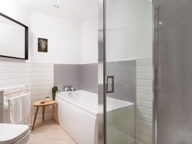 A bathroom with a bathtub and shower cabin at Estuary Watch Lelant near Carbis Bay