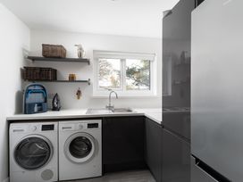 A laundry room with washing machine and tumble dryer at Estuary Watch Lelant near Carbis Bay