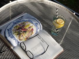 A book and a glass of lemon water on a table at Estuary Watch Lelant near Carbis Bay