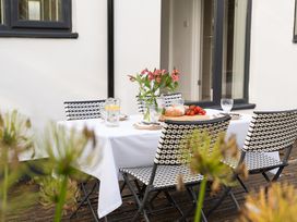 An outdoor dining area with a table and chairs at Estuary Watch Lelant near Carbis Bay