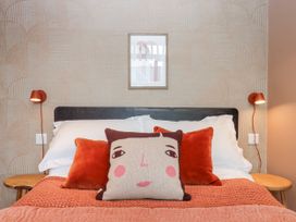 A bedroom with a bed and pillows at 3 Caddaford Barns Buckfastleigh