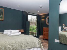 A bedroom with a bed and dressing table at 3 Caddaford Barns in Buckfastleigh