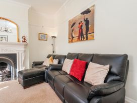 A living room with a sofa and fireplace at 50 West Street Edelweiss Scarborough