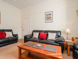 A living room with sofas and a coffee table at 50 West Street Edelweiss Scarborough