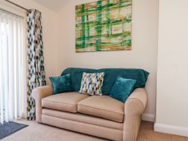 A living room with a sofa and wall art at 50 West Street Edelweiss in Scarborough