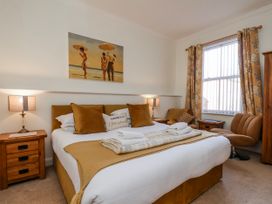 A bedroom with a bed and a nightstand at 50 West Street Edelweiss Scarborough