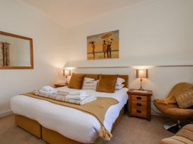 A bedroom with a bed and a bedside table at 50 West Street Edelweiss Scarborough
