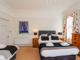 A bedroom with a bed and wardrobe at 50 West Street Edelweiss Scarborough