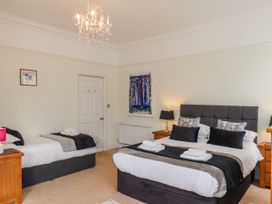 A bedroom with two beds and nightstands at 50 West Street Edelweiss Scarborough