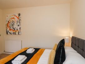 A bedroom with a bed and artwork at 50 West Street Edelweiss in Scarborough