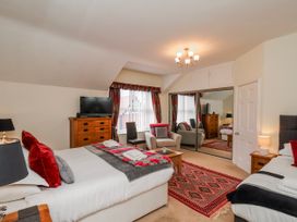 A bedroom with two beds and a television at 50 West Street Edelweiss Scarborough