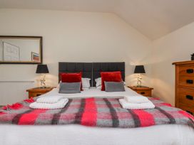 A bedroom with a bed and dresser at 50 West Street Edelweiss in Scarborough