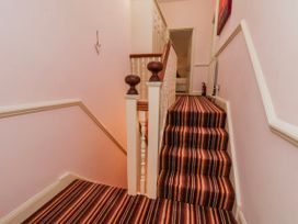 A stairway with carpet and a handrail at 50 West Street Edelweiss Scarborough