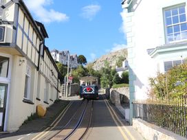 A tram on a road between houses at The Keep in Llandudno