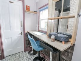 A kitchen with a table and chairs at The Keep in Llandudno