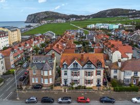 Aerial view of residential area with houses and a coastal landscape at The Keep Llandudno