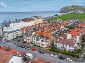 A coastal view of houses and roads near the ocean at The Keep in Llandudno