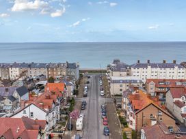 A view of buildings and a road leading to the ocean at The Keep in Llandudno