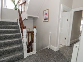 A staircase and hallway with a framed picture at The Keep in Llandudno