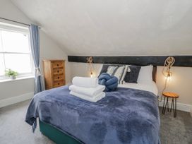 A bedroom with a bed and drawers at The Keep in Llandudno