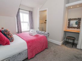 A bedroom with a bed and desk at The Keep in Llandudno