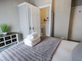 A bedroom with towels on a bed at The Keep in Llandudno