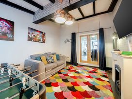 A living room with a sofa and a foosball table at The Keep in Llandudno
