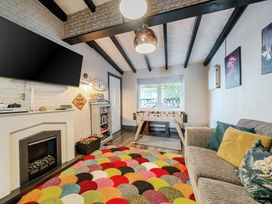 A snug with a sofa and foosball table at The Keep in Llandudno