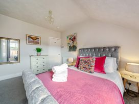 A bedroom with a bed and side table at The Keep in Llandudno