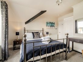 A bedroom with a bed and bedside table at The Keep in Llandudno