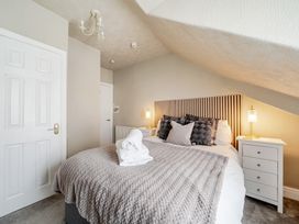 A bedroom with a bed and bedside table at The Keep in Llandudno